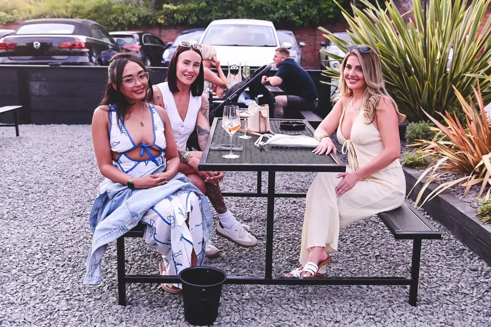 Friends sharing drinks on a pub terrace